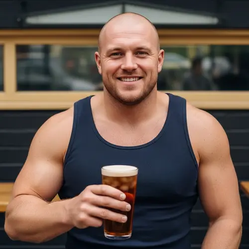 Broad-Shouldered English Man with Pint of Stella in Casual Setting