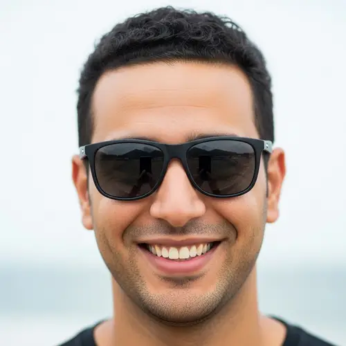 High-Quality Image of Middle-Eastern Man with Short Curly Hair and Black Sunglasses Smiling