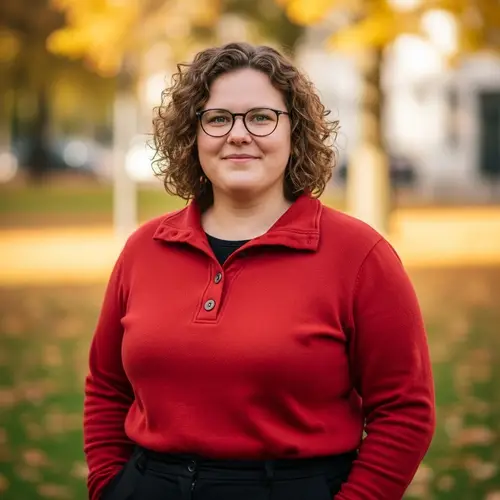 Smiling Woman with Curly Light Brown Hair in Red Pullover