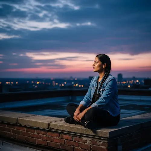 Urban Serenity: South Asian Woman in Denim Jacket on Rooftop at Sunset