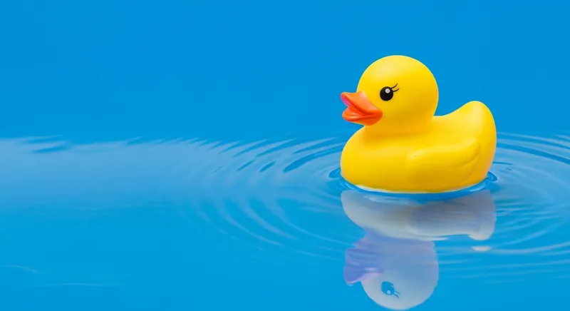 Vibrant Yellow Rubber Duck Floating in Tranquil Blue Water
