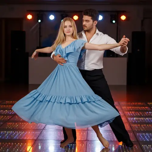 Dynamic Dance of Blonde Girl and Brunette Man on the Illuminated Dance Floor