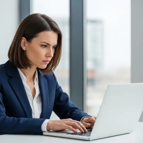 Caucasian Businesswoman in Navy Blue Suit Working on Laptop