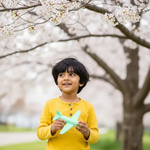 Young South Asian Boy Playing Under Cherry Blossom Tree