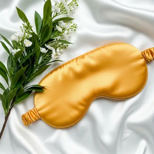 Golden Silk Sleep Mask on White Silk Sheet | Elegant Nature Contrast