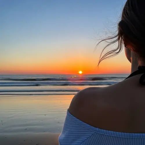 Tranquil Beach Scene with Person Showing Shoulder