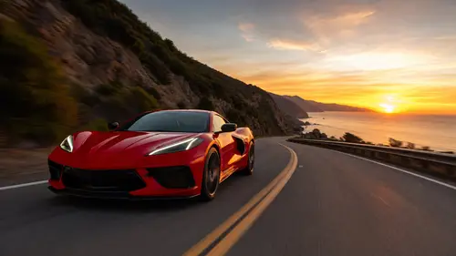 Sleek Red Sports Car on Coastal Mountain Road