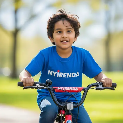 Young Boy Riding Bicycle with Nyirenda T-Shirt