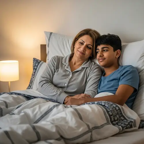 Loving Middle-Eastern Mother with 18-Year-Old Son Cuddling in Bed