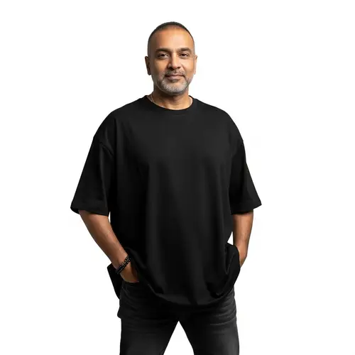 Confident Mature South Asian Man in Oversized Black T-Shirt