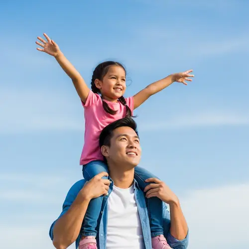 Ecstatic Hispanic Girl on Asian Man Shoulders | Bright Sky Scene