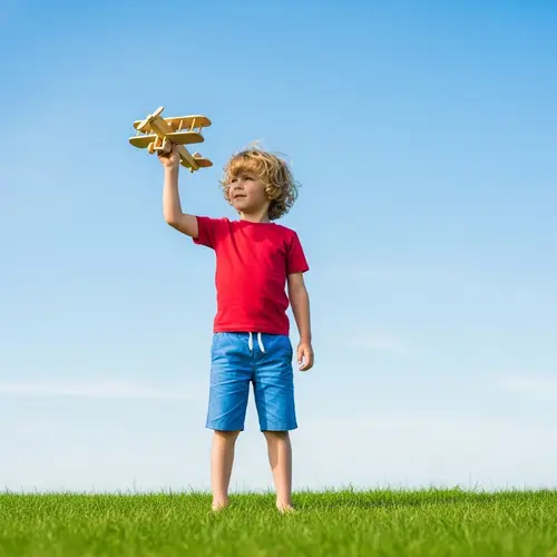 Young Boy with Wooden Toy Airplane | Outdoor Summer Play