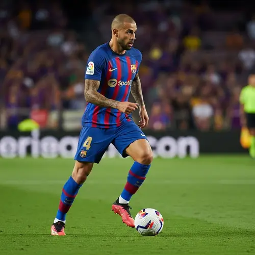 Male Professional Football Player Dribbling Across Field