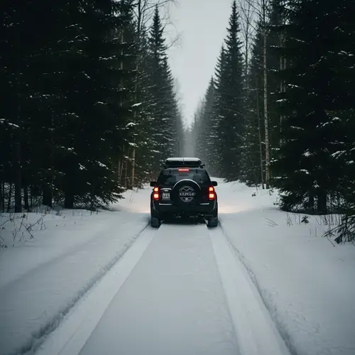 Car Driving on Snowy Trail in Dark Forest