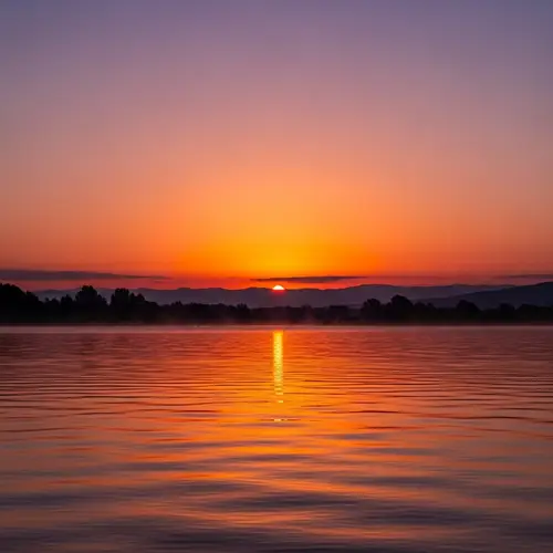 Breathtaking Dawn Scene: Calm Water & Stunning Hues