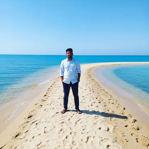 Serene South Asian Male at Sandy Spit in Bright Blue Water