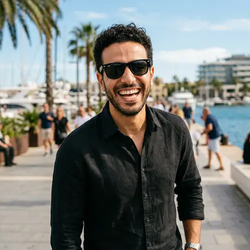 High-Quality Image of Middle-Eastern Man with Short Curly Hair and Black Sunglasses Smiling