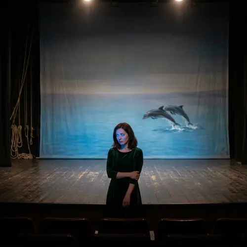 Solitary Figure in Sadness with Glowing Blue Eyes and Dolphins in the Distance