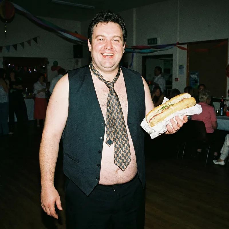 Fat Male Stripper with Submarine Sandwich