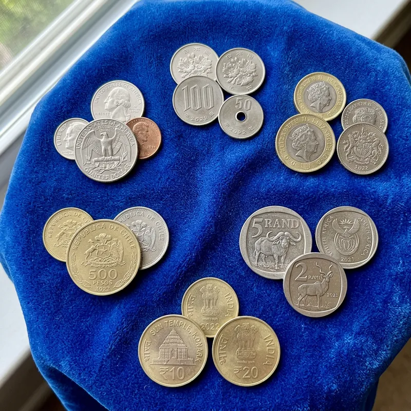 Official Coins: Global Collection on Blue Velvet Fabric Featuring Distinctive Coins from Various Countries