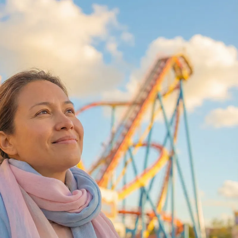 Joyful Model Smiling Amidst Vibrant Rollercoaster Joyful Model Smiling Amidst Vibrant Rollercoaster