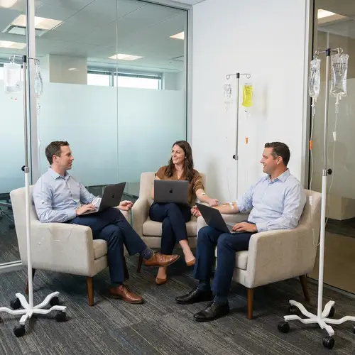 Colleagues Receiving IV Drips at Work