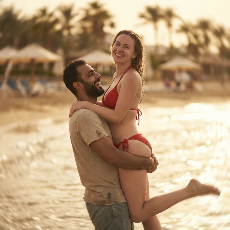 Joyful Ocean Love: Middle-Eastern Man Lifts Woman
