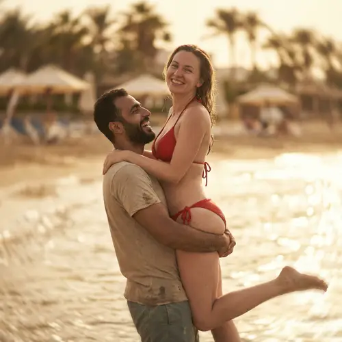 Joyful Ocean Love: Middle-Eastern Man Lifts Woman