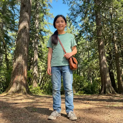 Asian 13-Year-Old Boy with Blue Eyes and Long Hair in Forest