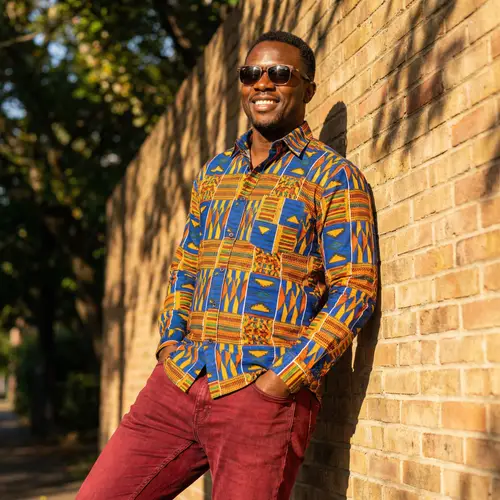 Vibrant Black Man in Colorful Shirt & Red Jeans