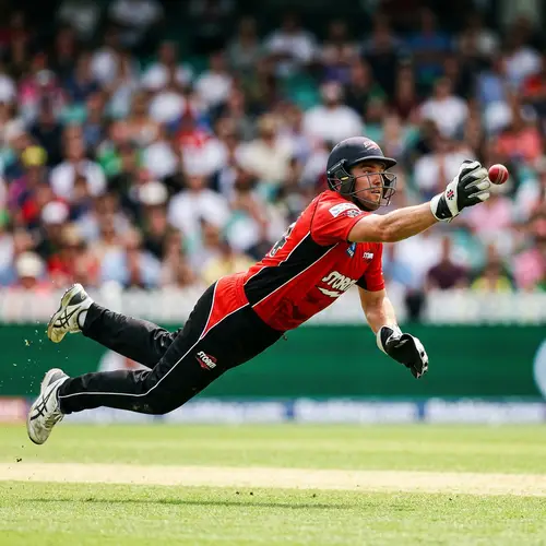 Dynamic Action Shot: Cricket Player Mid-Air Catching Cricket Ball