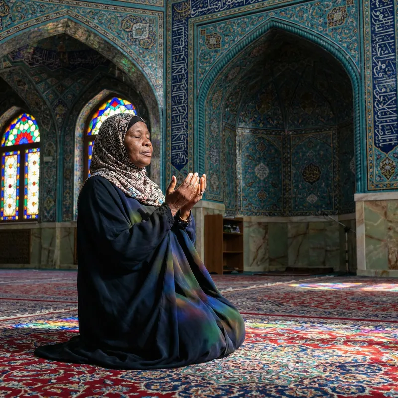 Black Muslim Woman in Prayer in Exquisitely Decorated Mosque