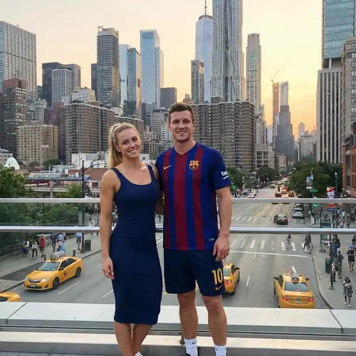 Elegant Woman & Athletic Man in Cityscape | Fashion Icon & Ball Player