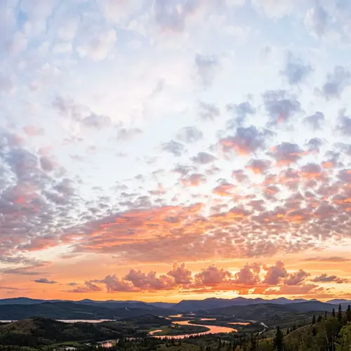 Realistic Sunset Sky with Multicolored Small Clouds