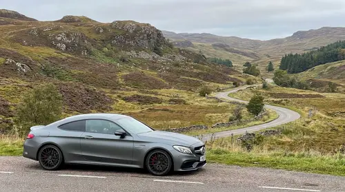 Scenic Scottish Hills and Roads Behind the Car