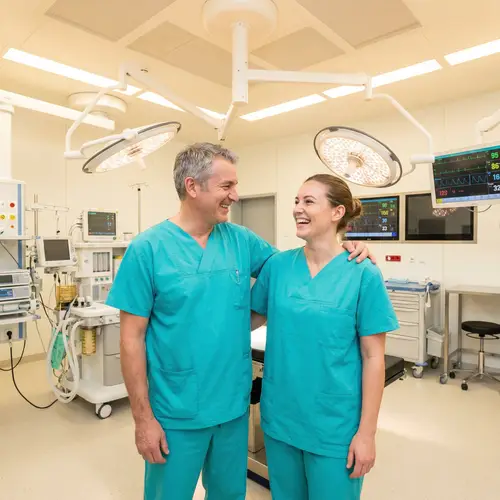 Joyful Surgeons and Nurses in Teal Scrubs