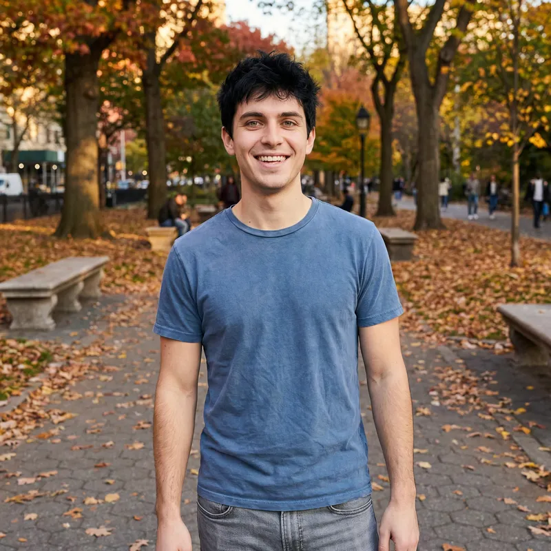Young Man in Urban Park with Autumn Leaves