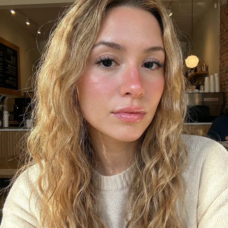 Stunning Blonde Woman with Strikingly Black Eyes and Glossy Pouty Lips