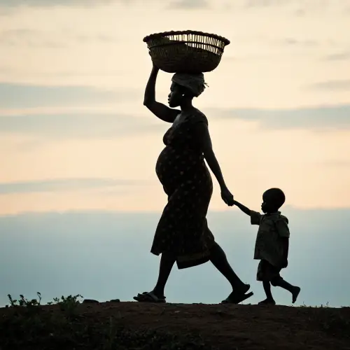 Silhouette of a Pregnant African Woman with Child