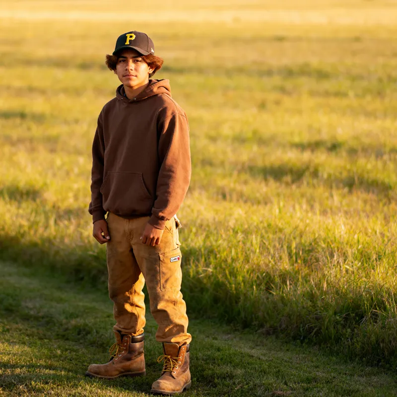 17-Year-Old Mexican Man in Work Boots and Hoodie
