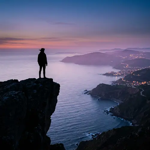 Dark Silhouette on Majestic Cliff Overlooking Lilac Hills and Ocean View