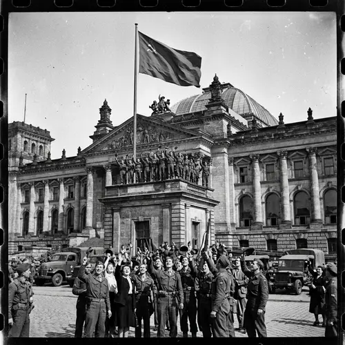 Iconic Red Flag Flying Over Historic Government Building