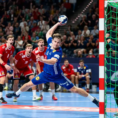 Dynamic Handball Shot in a Thrilling Match Moment