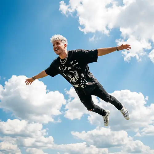 Travis Scott Soaring in Vibrant Sky | Modern Musician