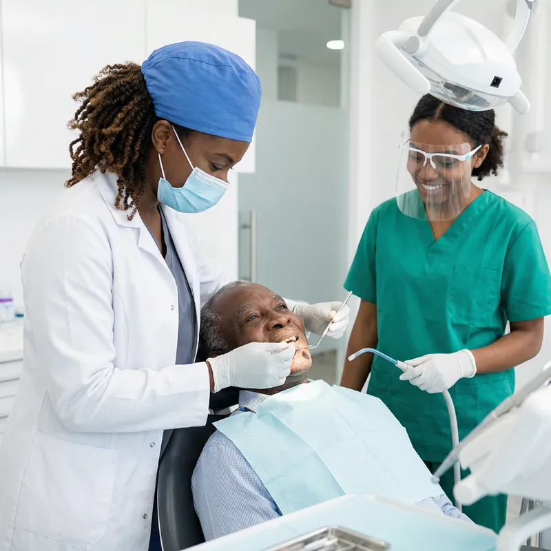 African Woman Dentist Helping Patients in Uniform