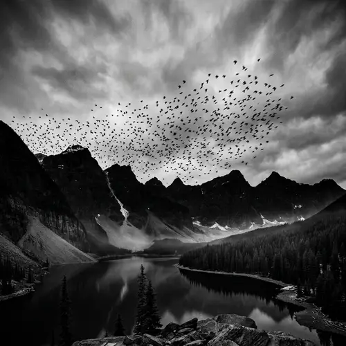 Scenic Silhouette of Large Mountains with Flock of Birds