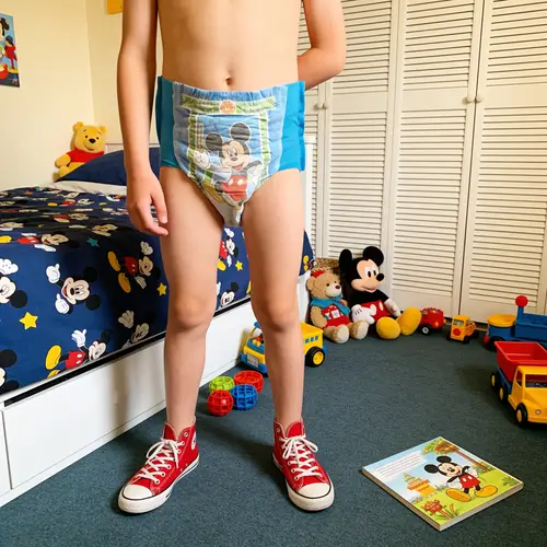 Smiling 10-Year-Old Boy in Bedroom with Toys