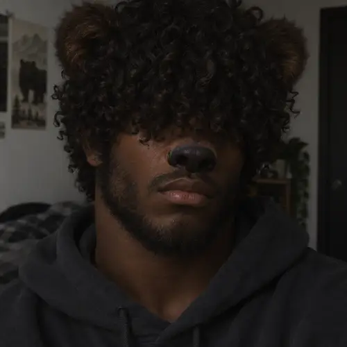 Young Man with Curly Hair and Bear-Like Features
