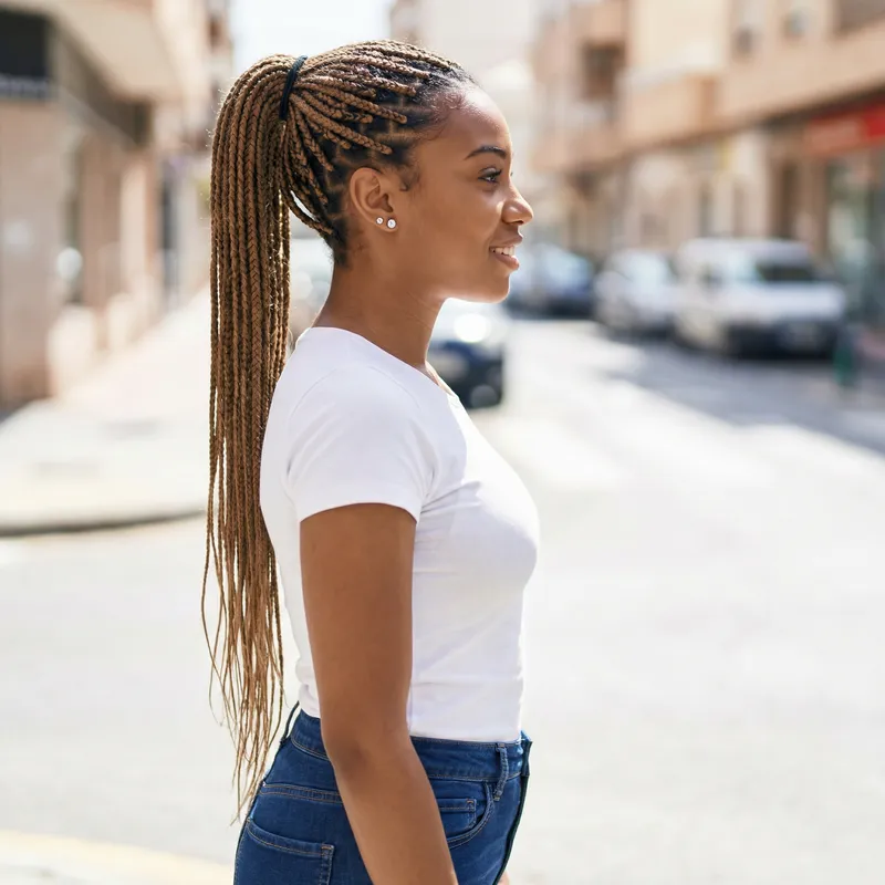 Stylish African American Woman with Box Braids and Diamond Stud Earrings