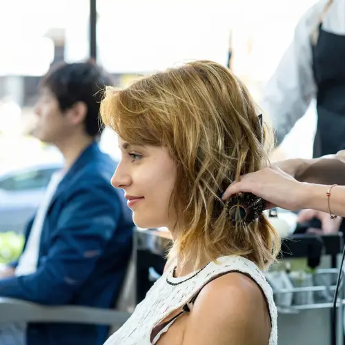 Woman Getting Hair Styled at Salon